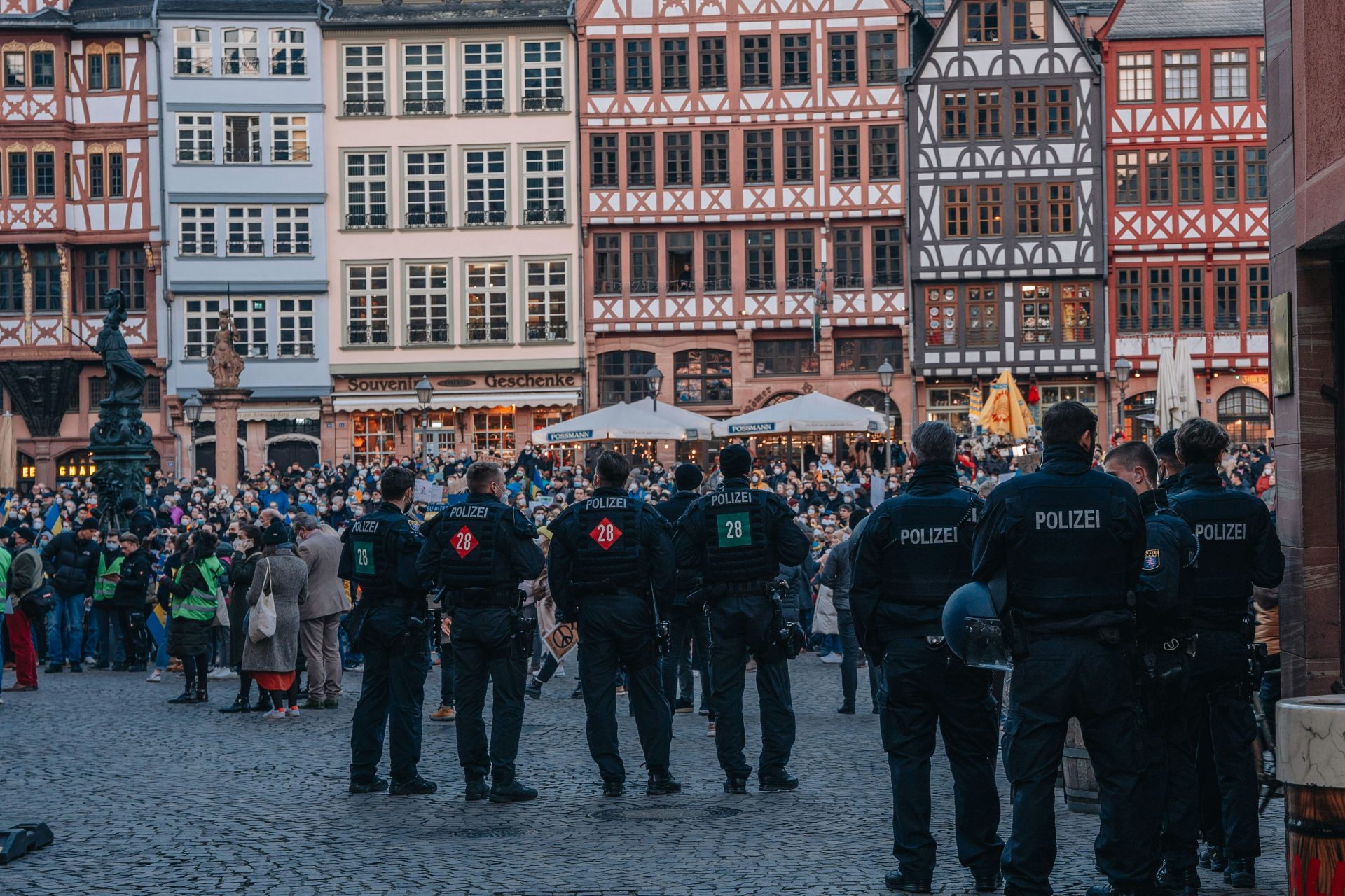 Eine Gruppe Polizisten steht vor einer Menschenmenge.